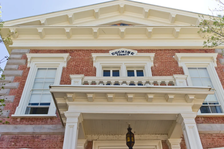 a tall brick building with a clock at the top of it