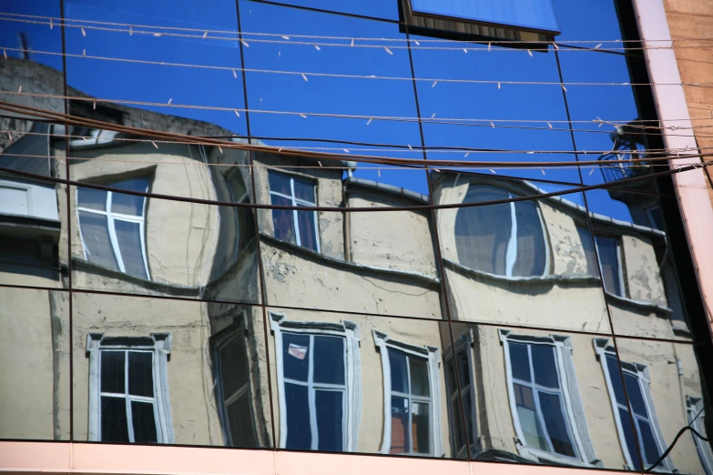 the reflection of a building in an apartment window