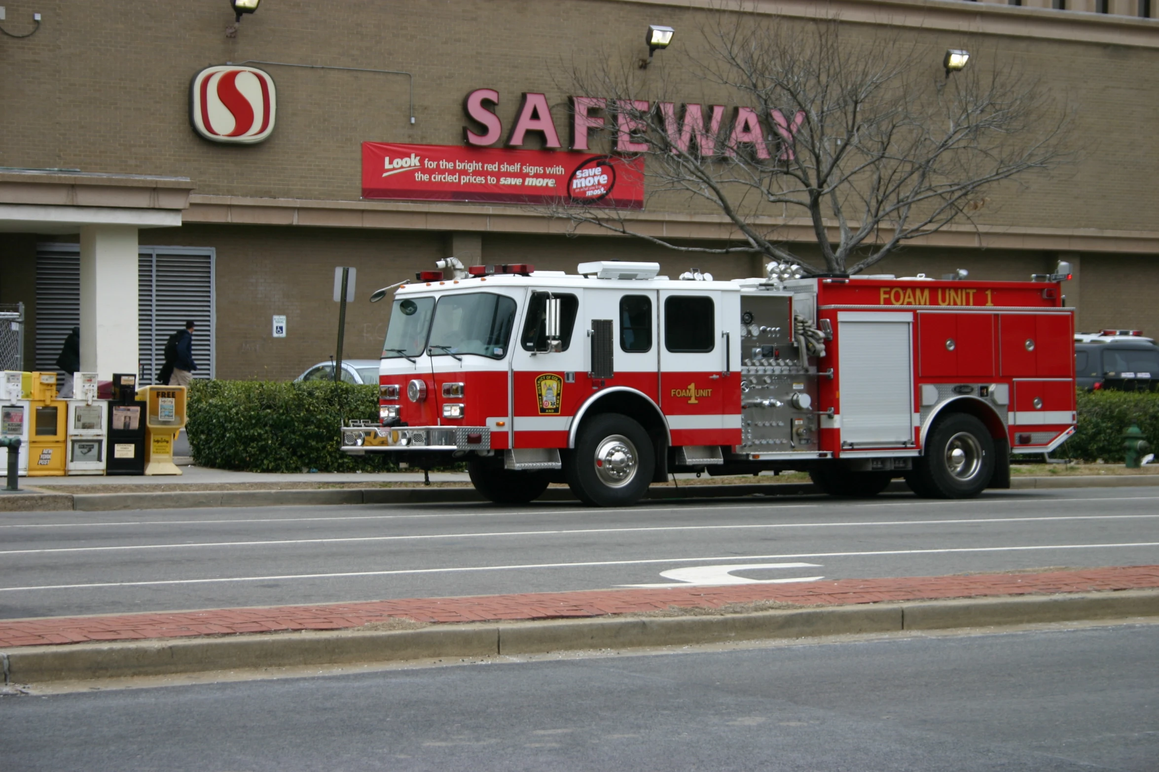 a firetruck that is parked in front of a safeway store