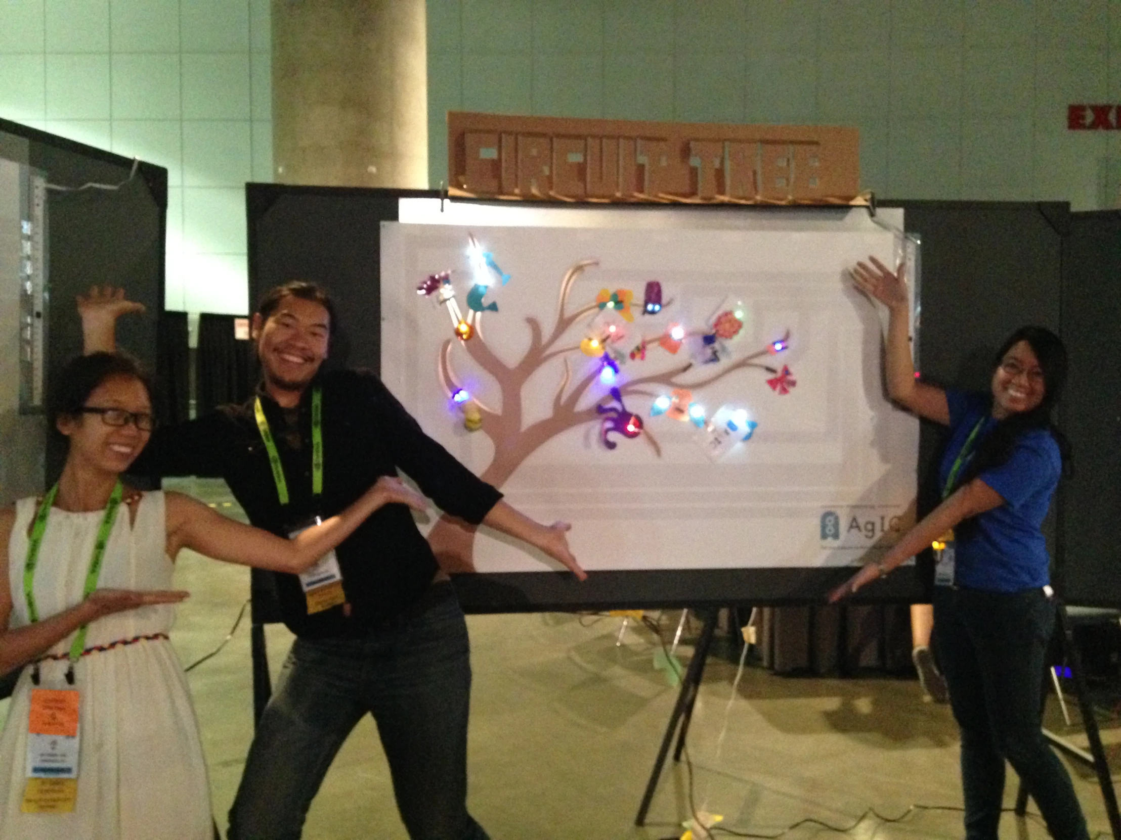 a group of people that are standing in front of a large poster