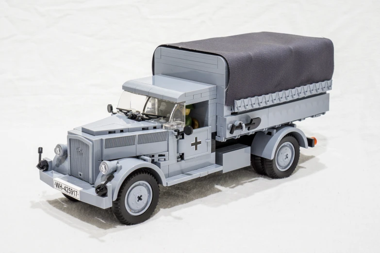 a grey toy truck with a large black canvas on it
