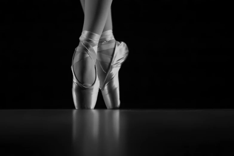 the feet of a ballerina in the ballet outfit