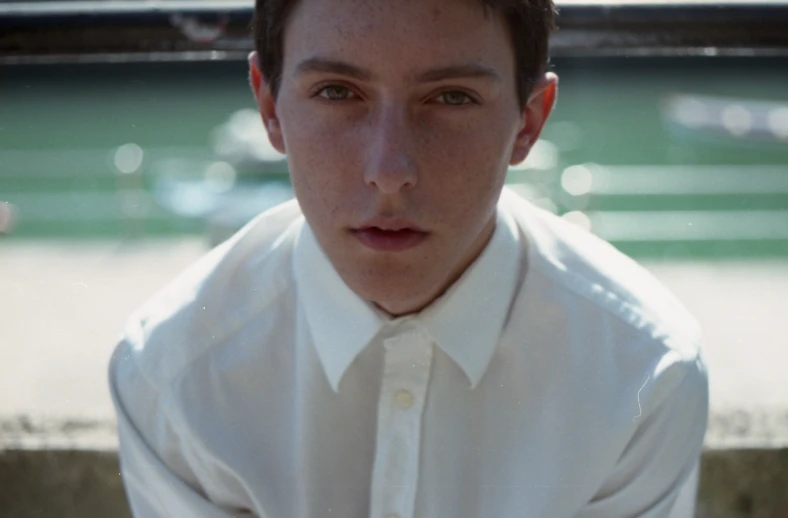 a close up of a man wearing a white shirt and tie