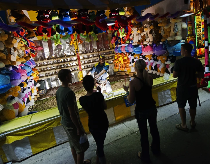 people standing at the top of a carnival ride