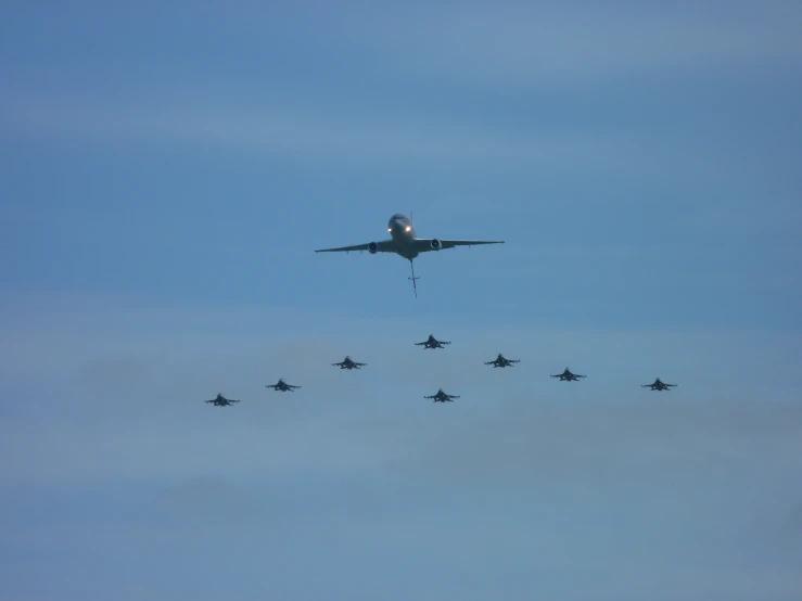 an airplane that is flying over some airplanes