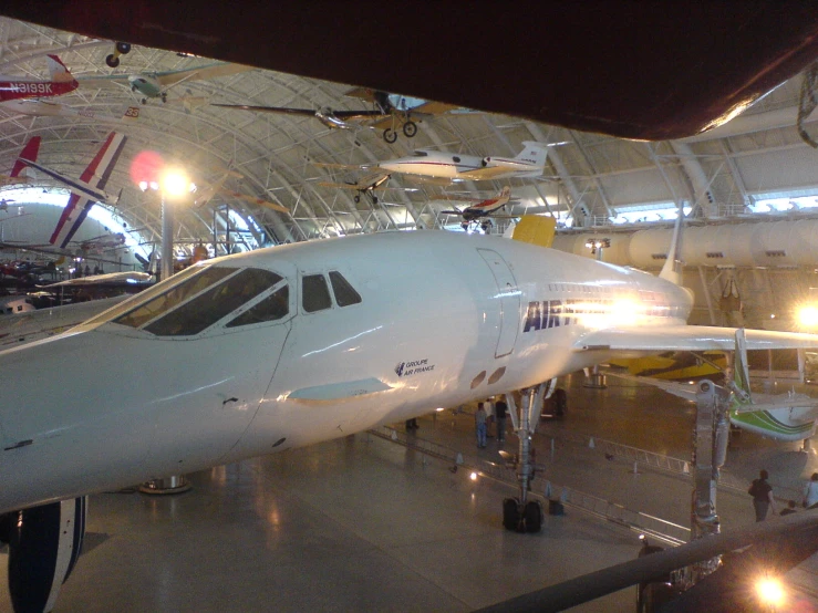 an airplane being worked on inside a hangar