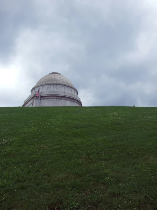 the building is atop the hill by it's top