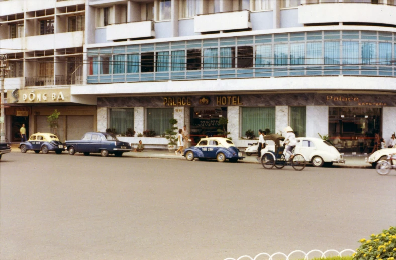 a couple of cars parked in front of a building