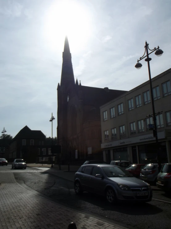 cars are parked in front of large, dark brown church