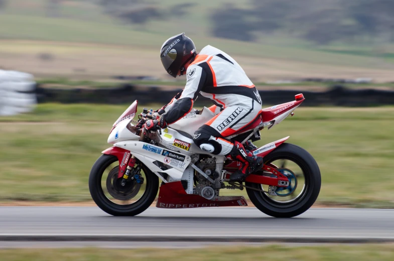 a man riding on the back of a white motorcycle