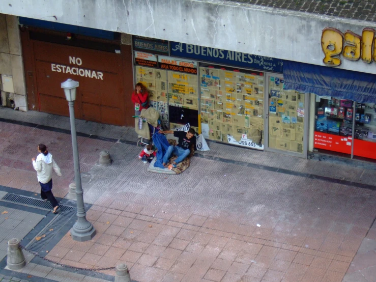 a woman with an umbrella and a child in front of a store