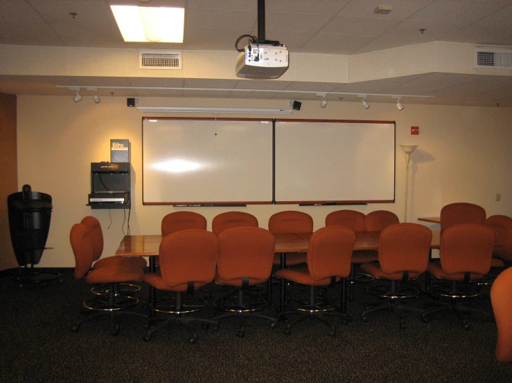 chairs and a projector in an empty room