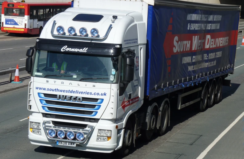 an eighteen wheeler truck drives down the street