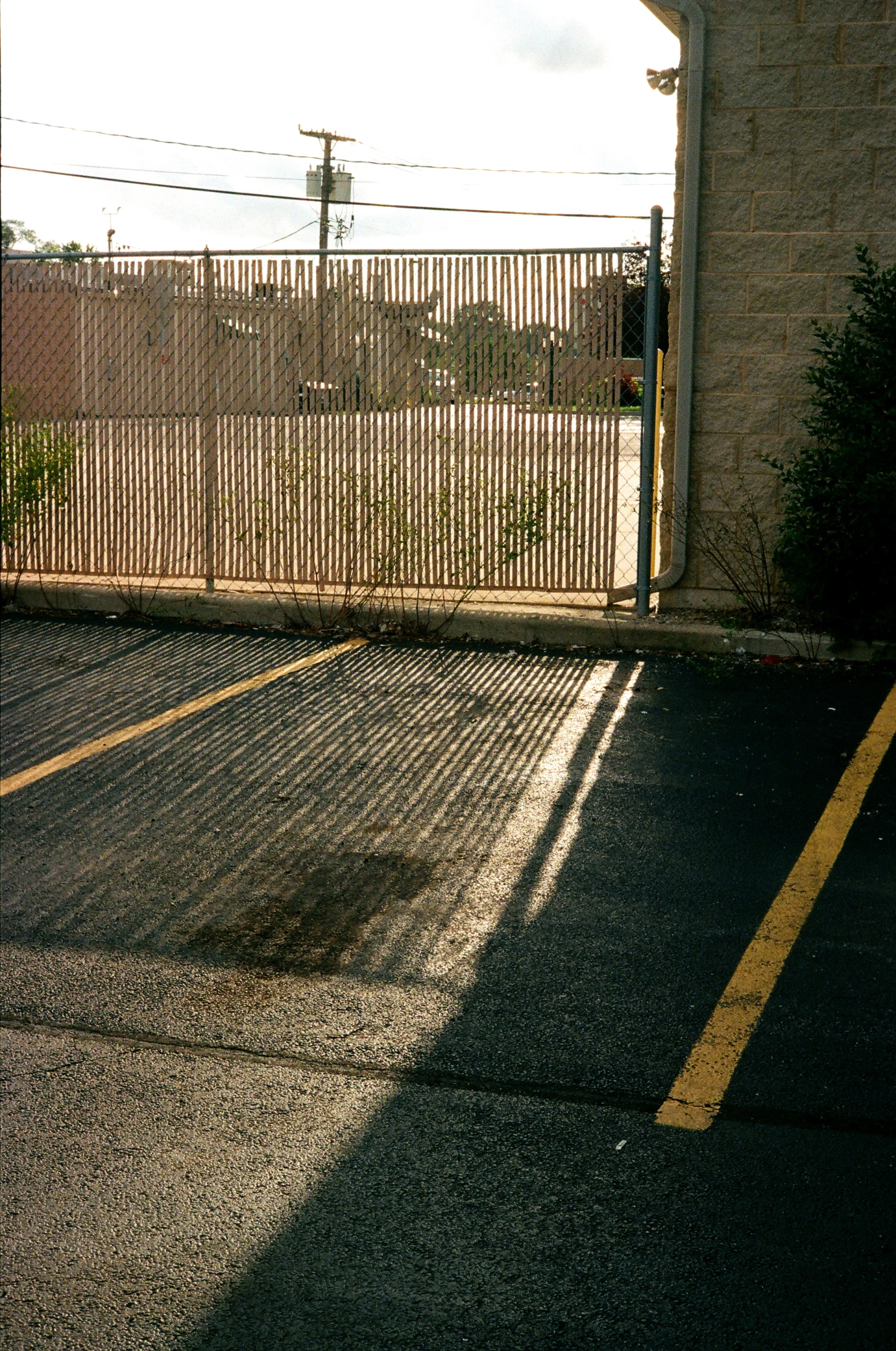 a parking lot is pictured near a gate