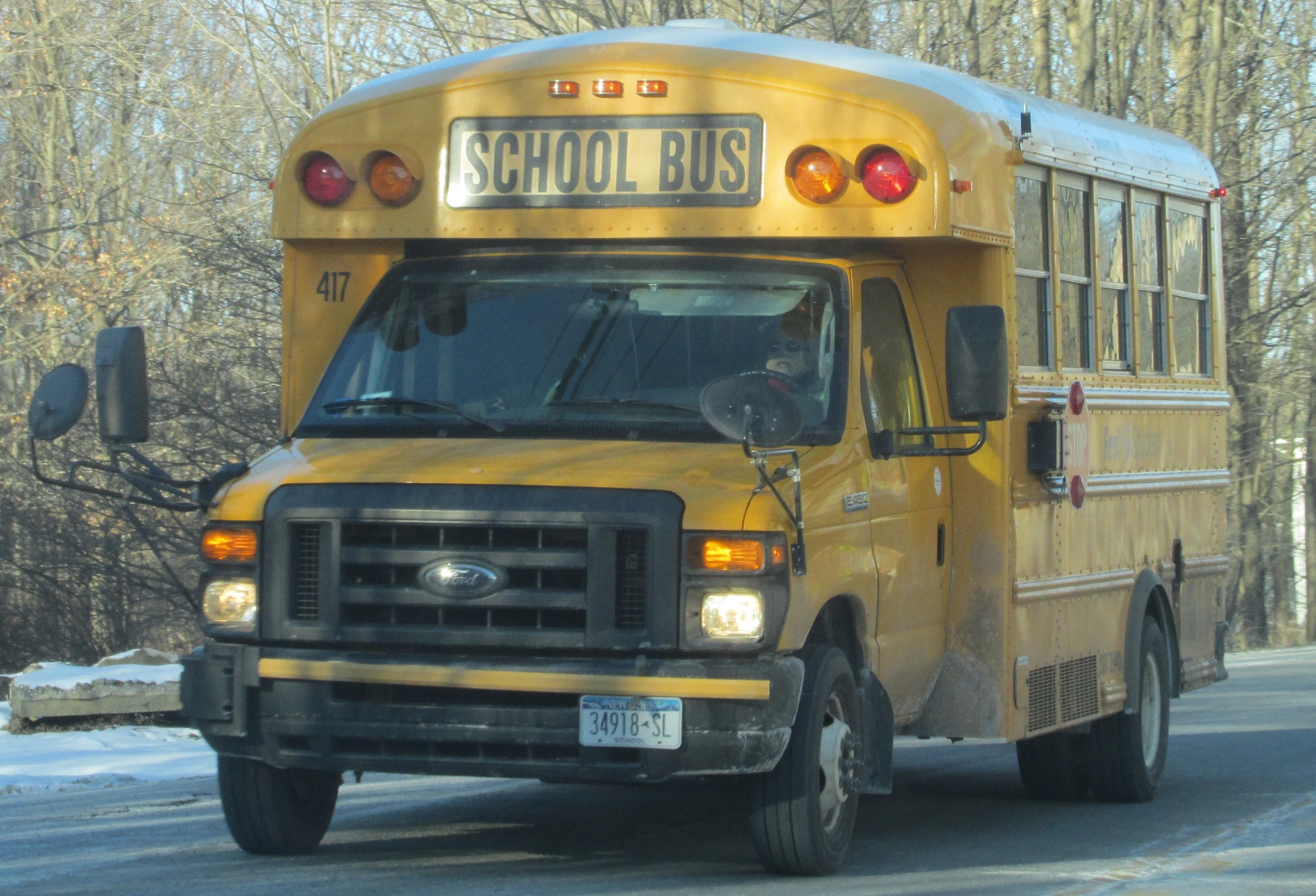 a yellow bus is driving down the road