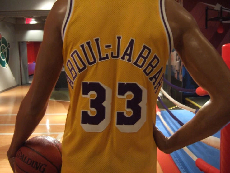 the basketball player is holding his uniform on and wearing his number 34