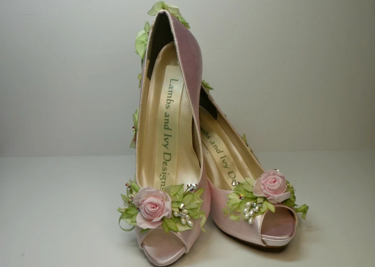 some pink high heels with flowers on them