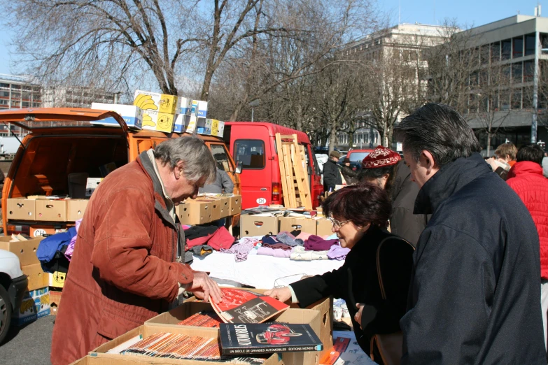 two men buying stuff at a farmers fair