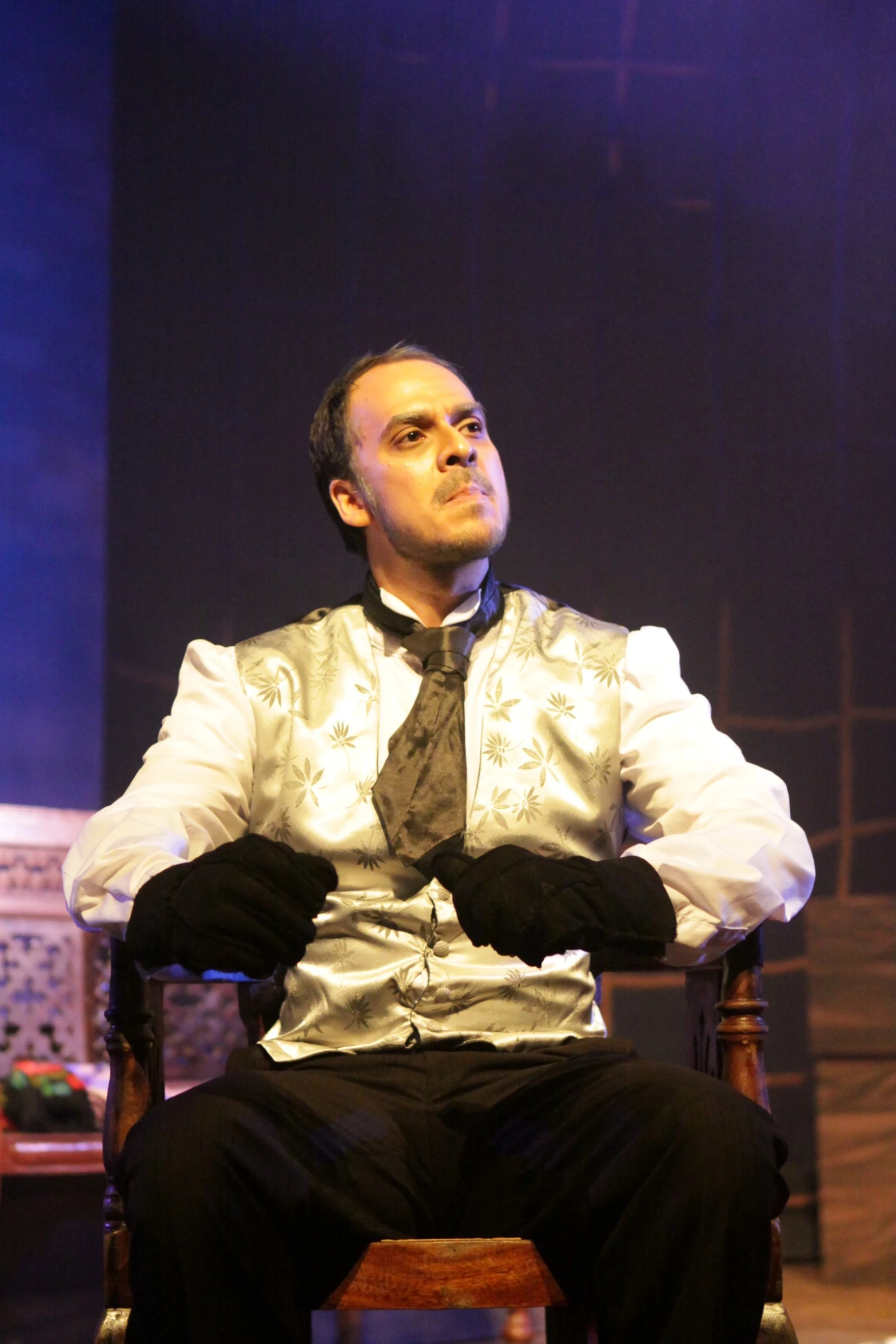 a man sitting in a chair on a stage