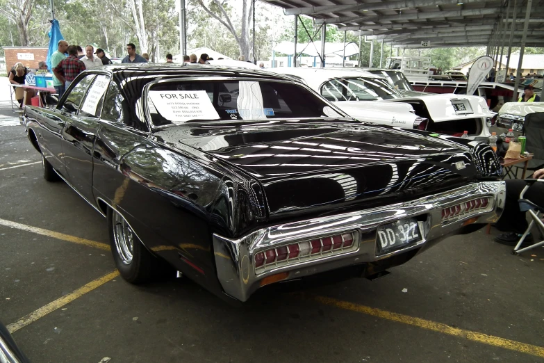 a car show is underway and many people are watching it