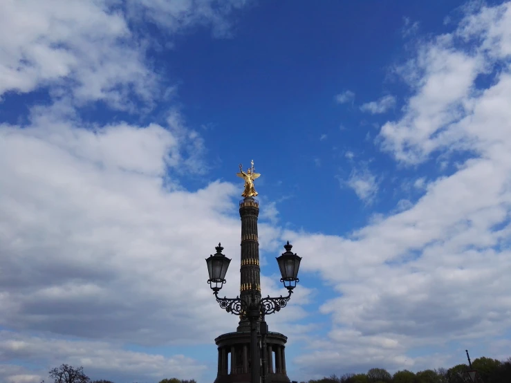 a beautiful street lamp surrounded by the sky