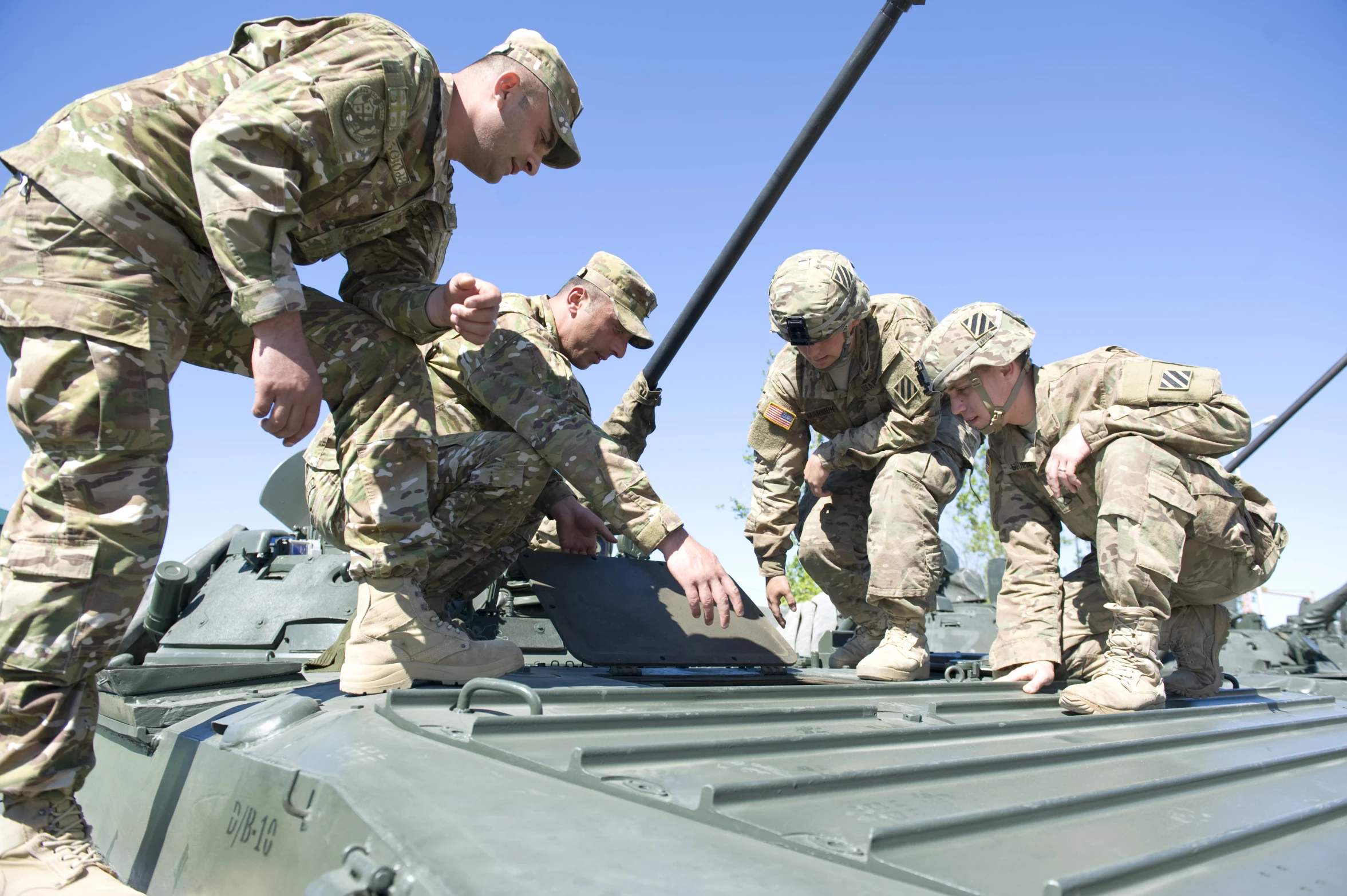 some soldiers are tying soing to an object