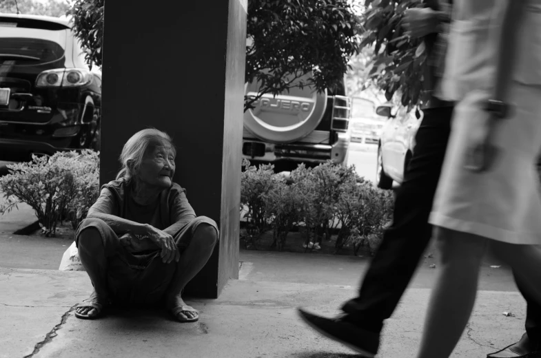 a man sitting on the ground while talking on a cell phone