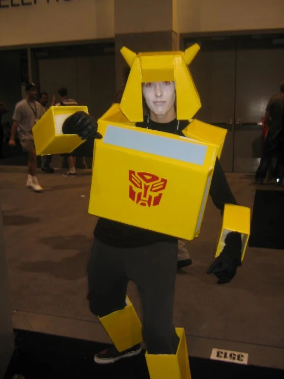 a man in a yellow robot suit that is standing