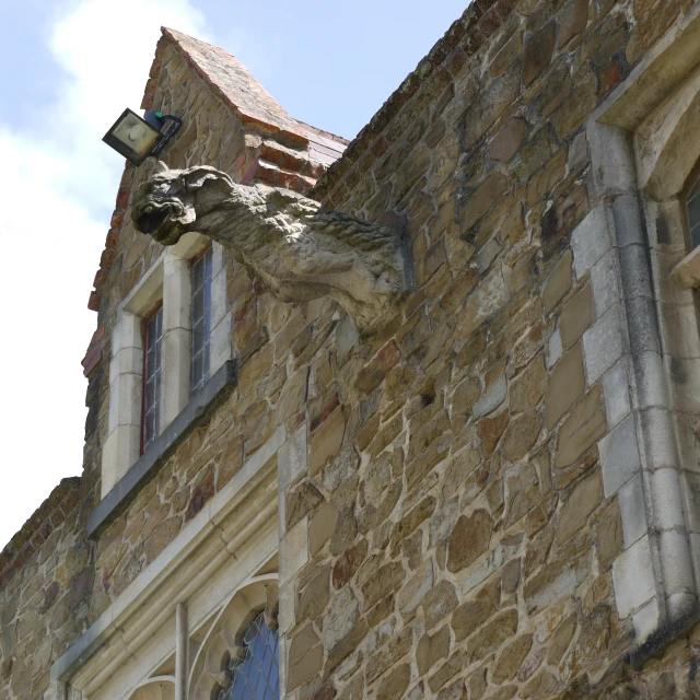 an old brick building with a bird on top