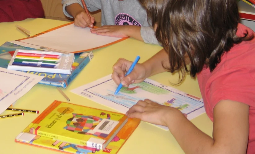 s are using pens and papers at the table