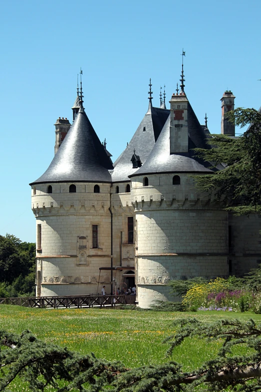 a building with turrets and a large park area