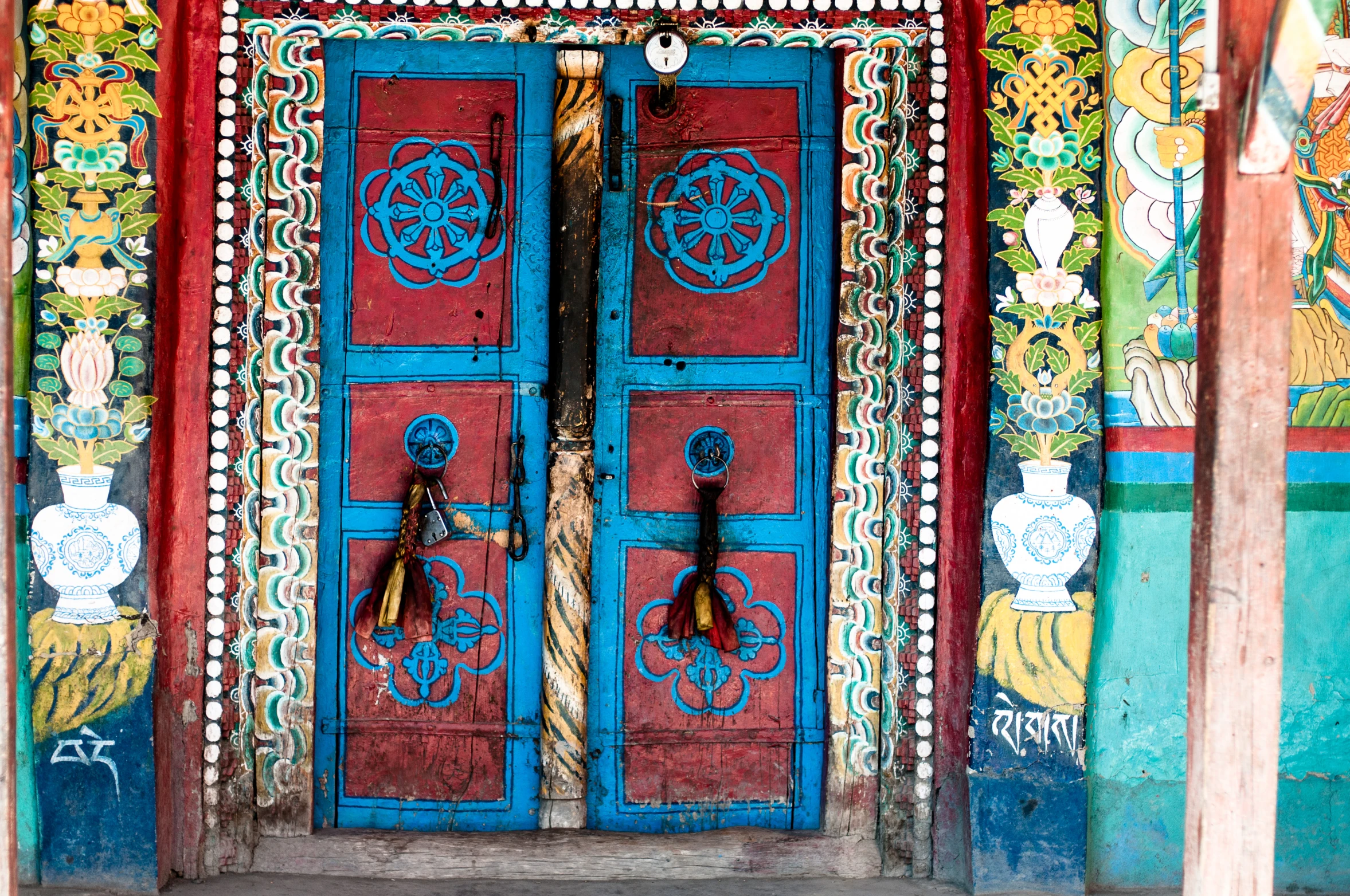 colorful doorways with designs on the wall and painted doors