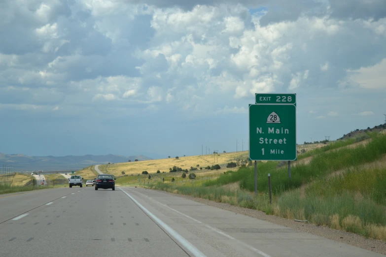 highway traffic on road with signs that indicate where you should drive