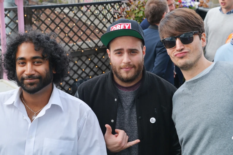 the three men are posing together for a po