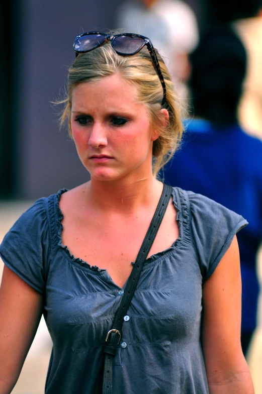 a woman in glasses staring at the camera