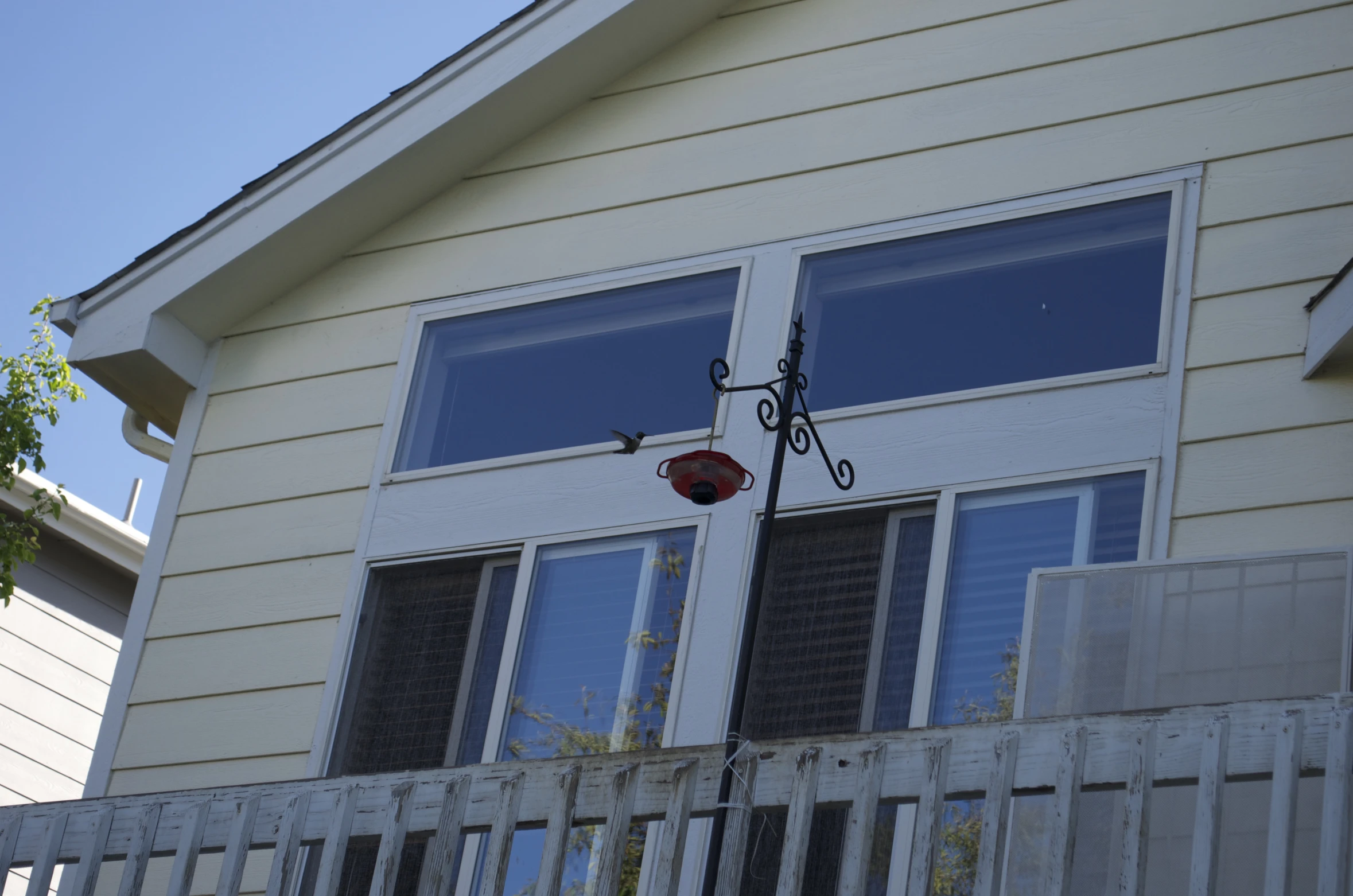 the front porch of a house has two windows