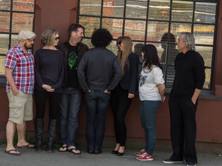 several people standing in front of a window