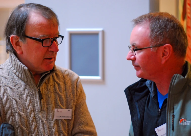 two men having conversation next to each other