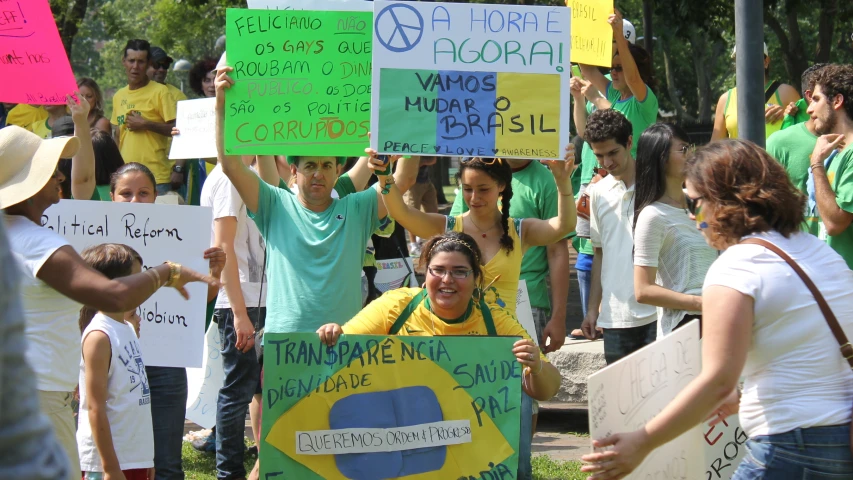 a group of people standing together holding signs