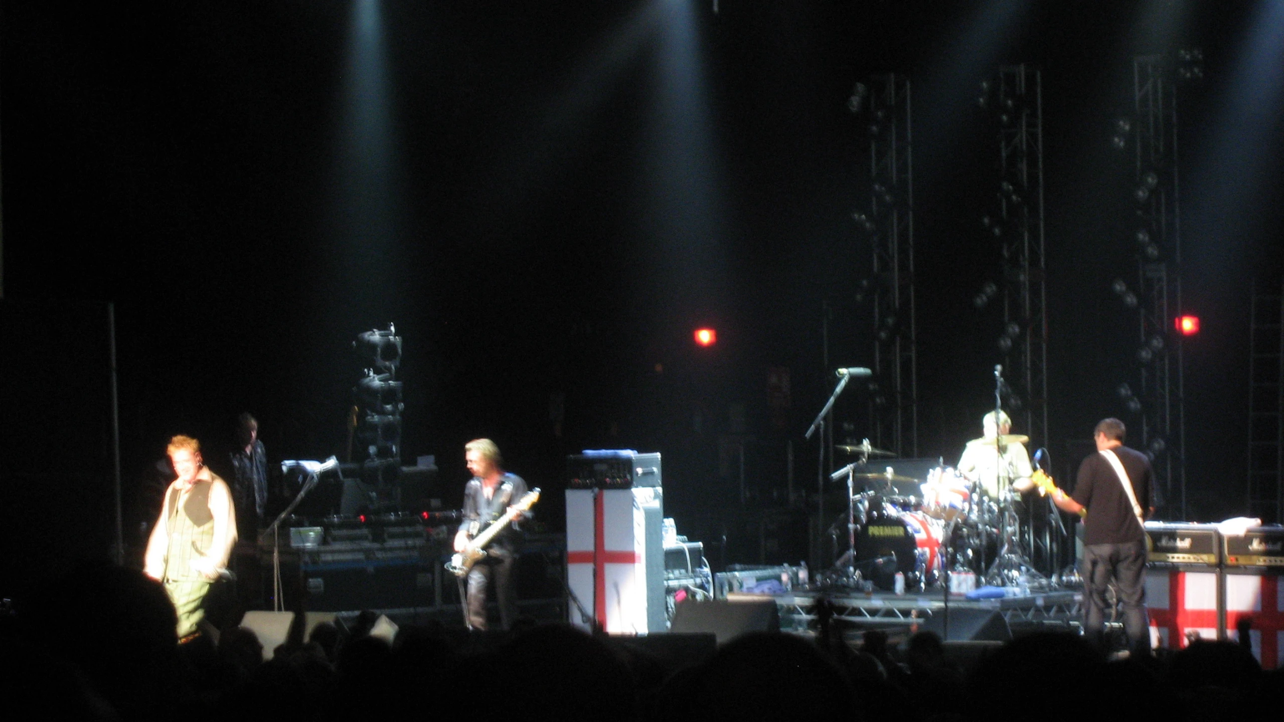 some people in front of a stage with lights on