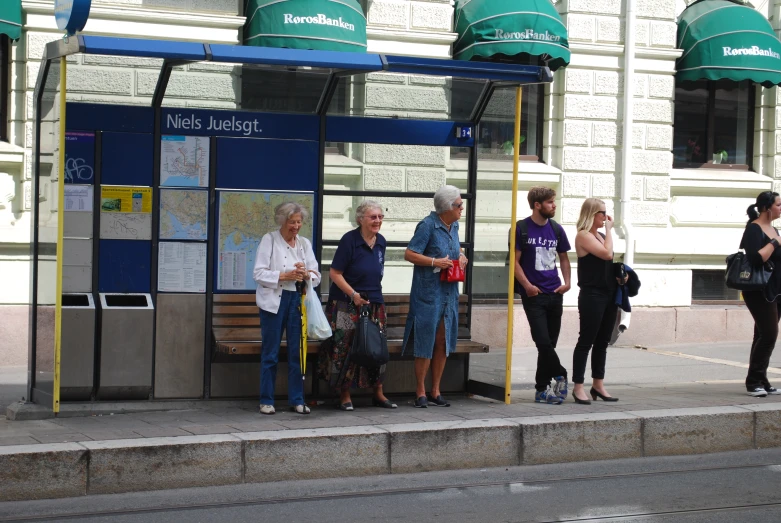 the group of people are waiting in the bus station