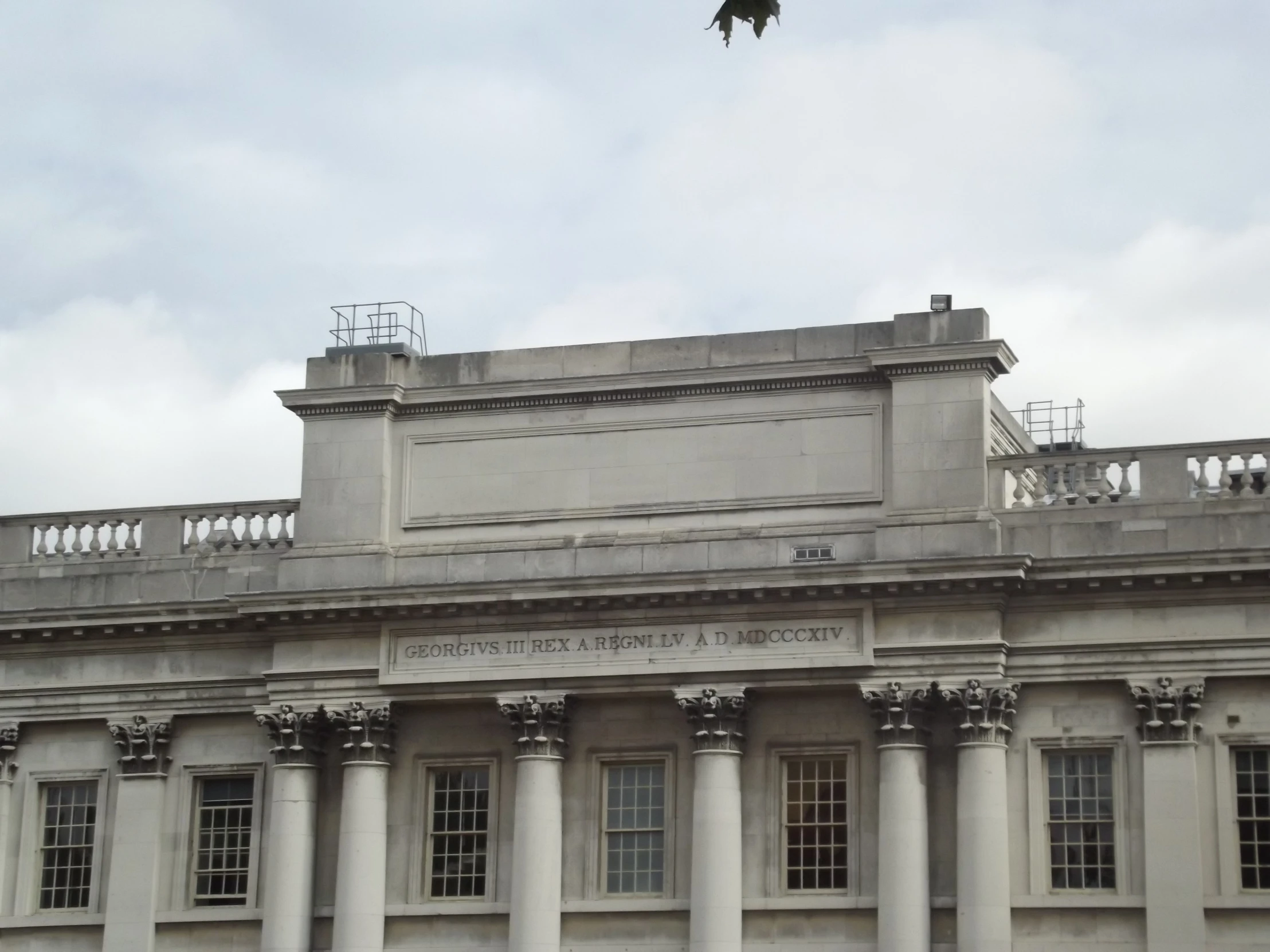 a bird flies over an older architecture building