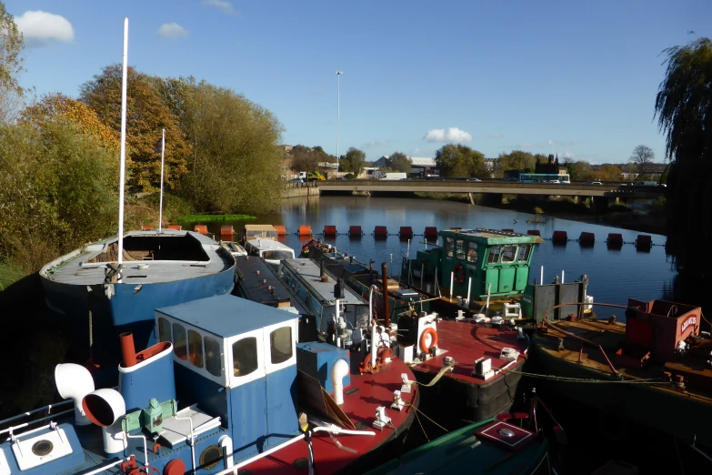 a large blue tug boat docked next to another green one