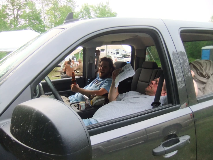 a man sitting in the drivers seat of his truck