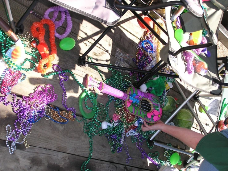 a little boy standing by a mardi gras decoration