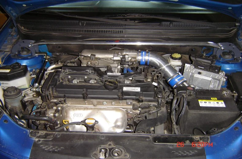 the engine of a small car showing the oil filter