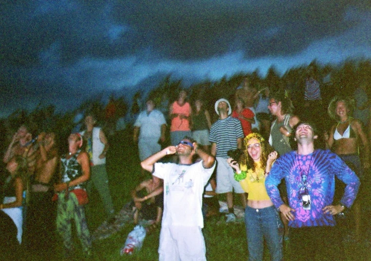 people standing around at an outdoor music festival