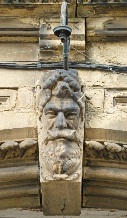 a decorative building decoration with a sculpture head