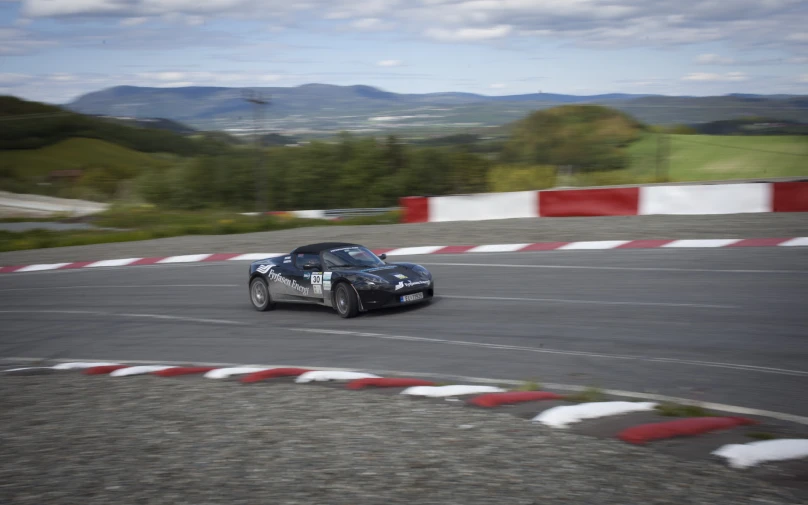 an old car driving on the race track