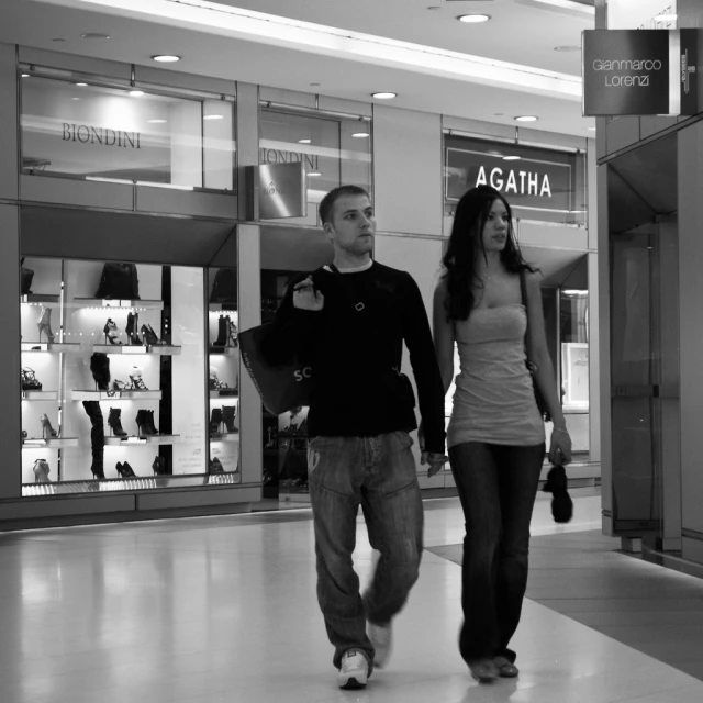 two people walking inside of a store